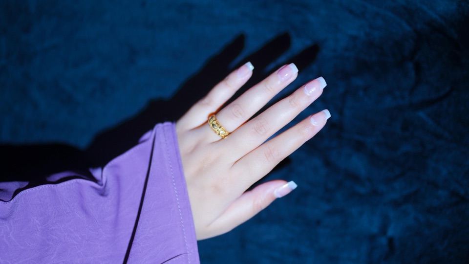Classic French-tip bridal press-on nails on outstretched hand — restrained Valima reception polish