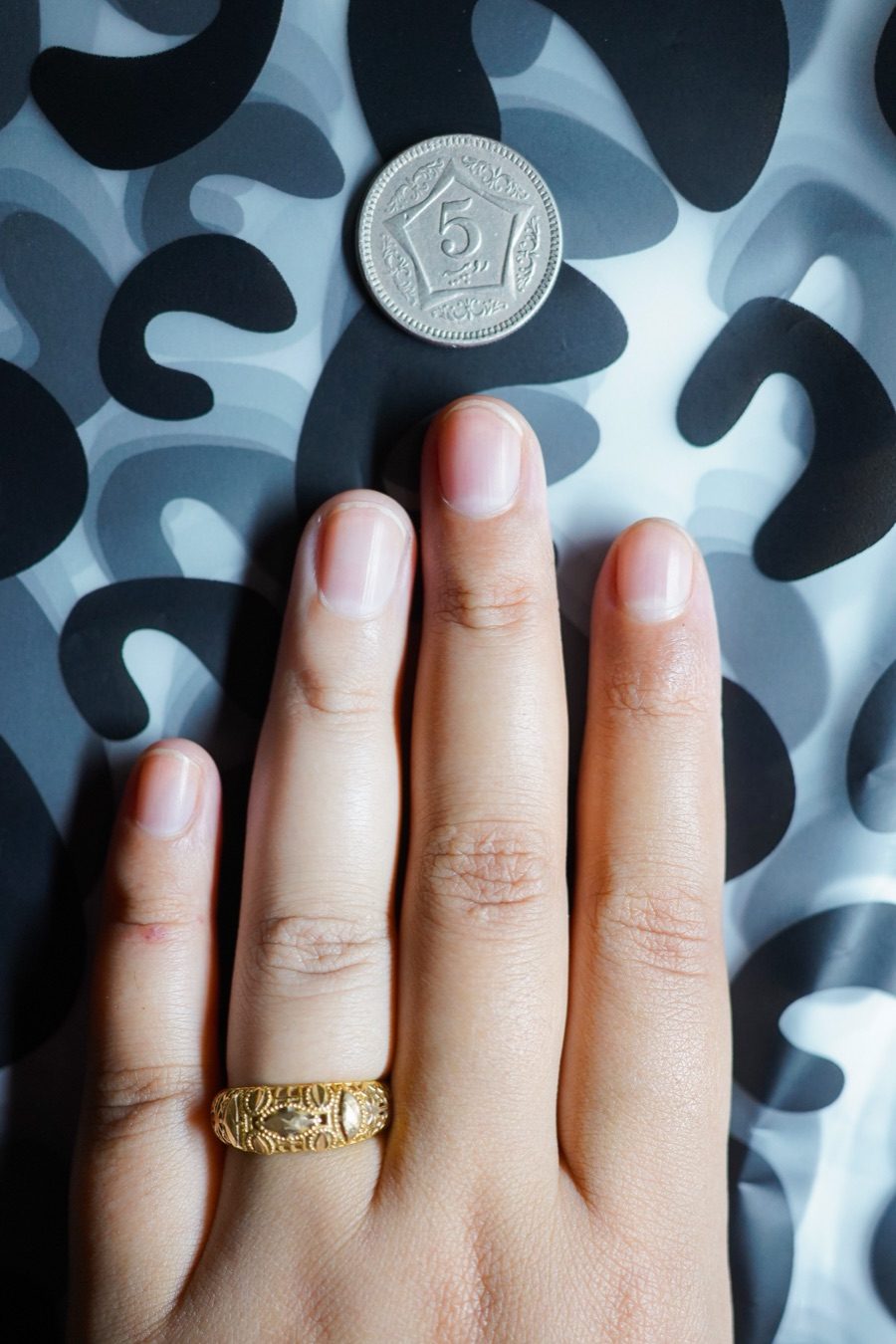 Hand on a busy patterned cushion — alignment border can't read it